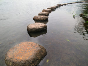 A stone road in the water. It can't be seen where the road will take you
